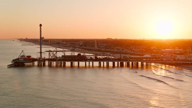 istock Sun Setting Behind Pier in Galveston, Texas - Aerial Shot 1395605719