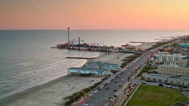 Aerial shot of the historic pier and the beach in Galveston, Texas at sunset. 

Authorization was obtained from the FAA for this operation in restricted airspace.