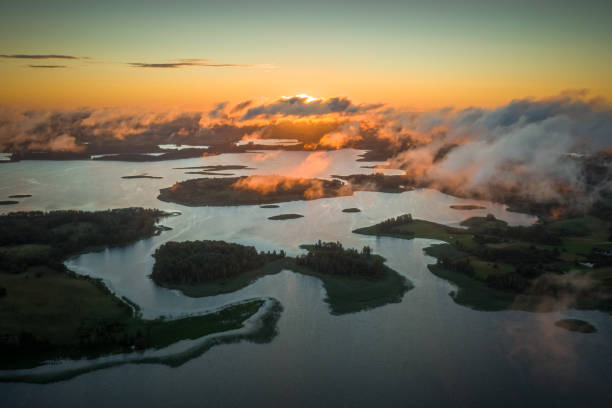 Amazing lake system view from above, islands of various shapes covered with trees and fresh meadows in morning sunlight. Aerial, drone flies over Braslav Lakes National Park on sunrise or sunset Amazing lake system view from above, islands of various shapes covered with trees and fresh meadows in morning sunlight. Aerial, drone flies over Braslav Lakes National Park on sunrise or sunset. braslav lakes stock pictures, royalty-free photos & images