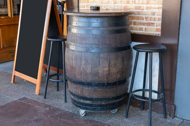 istock large wooden barrel used as a table and empty black restaurant menu advertising board on the outside of a restaurant 1395606643