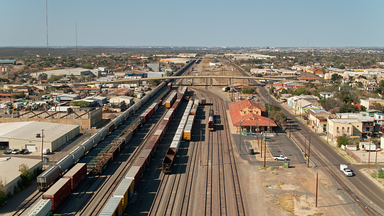 Aerial view of Laredo, Texas on a sunny afternoon over looking a freight train yard\n\nAuthorization was obtained from the FAA for this operation in restricted airspace.