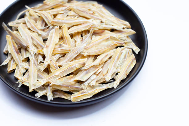 istock Dried anchovies on white background. 1395607889