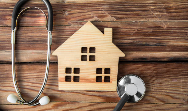 istock wooden house and stethoscope 1395608785