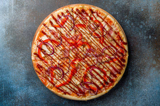 istock Pizza with chicken, bacon,red onion and barbecue sauce, bbq, on blue dark stone table top view 1395608964