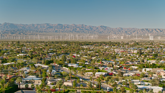 Aerial view of residential streets in the Las Palmas neighborhood of Palm Springs, California on a late sunny afternoon, looking towards the wind farm in the San Gorgonio Pass. \n\n\nAuthorization was obtained from the FAA for this operation in restricted airspace.
