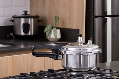 Practical silver pressure cooker in modern kitchen