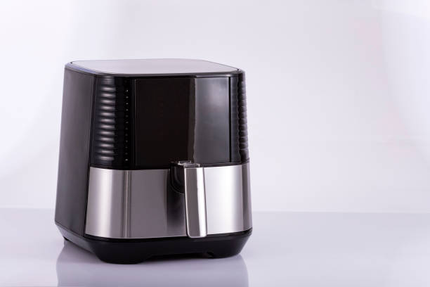 istock Modern digital hot air fryer on neutral background 1395615123