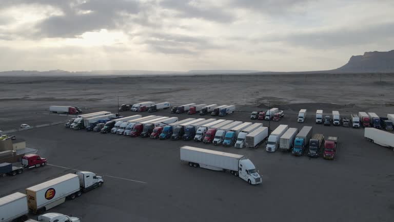 Aerial Drone Parked Semi-trucks at a big truck stop in the desert of Eastern Utah at Dusk