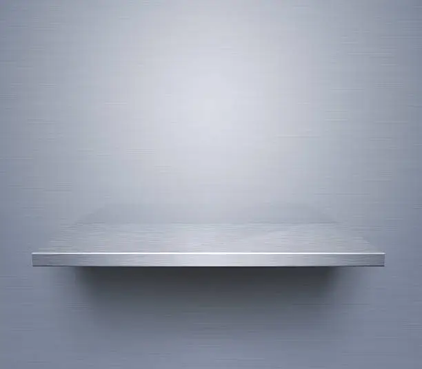 Empty brushed metal shelf at the wall