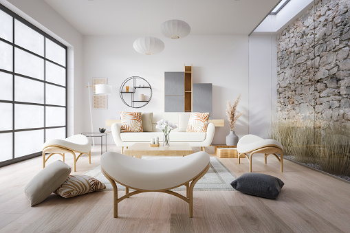 Corner of modern living room with white walls, wooden floor, cozy blue sofa standing near coffee table, comfortable fireplace and bookcase. 3d rendering