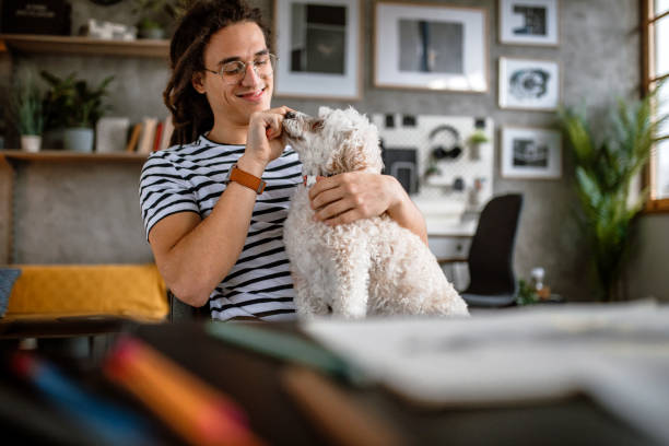 istock Cuddling with dog at work place 1395622137
