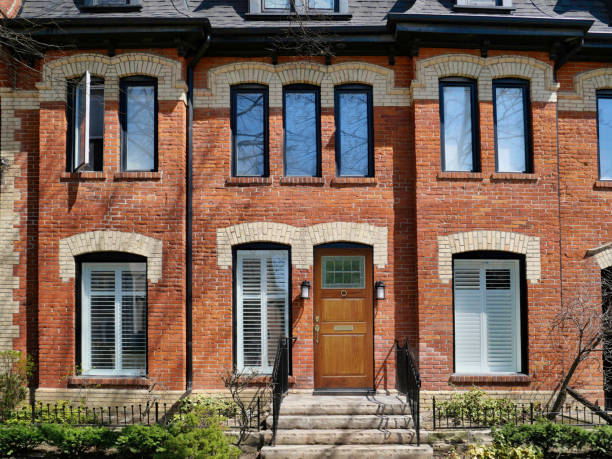 Toronto, Canada - April 24, 2022:  Restored and gentrified old row houses, with 19th century style multicolored bricks