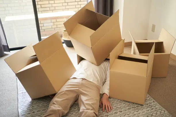 Asian man buried in a cardboard box