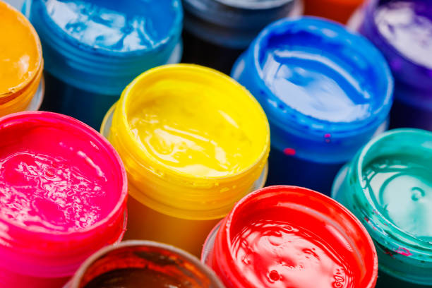istock full-frame close-up background of opened small gouache paint jars 1395631110