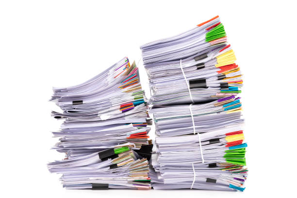 istock Stack of business papers isolated on white background 1395632592