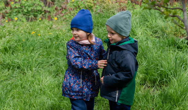 istock Two children playing outdoors on a sunny spring day 1395632773