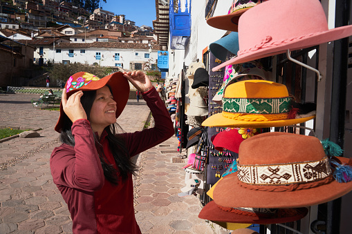 Tourist wearing a typical Cuzco hat in San Blas Square