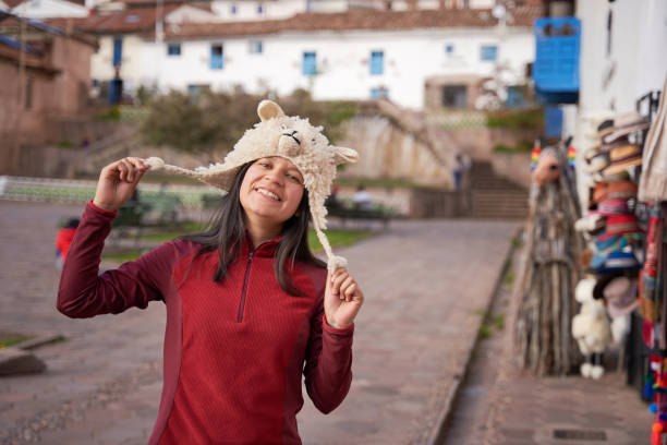 Tourist choosing a typical Cuzco llama hat in San Blas Square