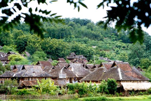 In the 1990s,traditional Dai Tribe village and house in Xishuangbanna The main building materials of these traditional houses are wood and bamboo, so they are also called Bamboo Tower. Unfortunately, now of after more than 20 years, people's living standards have improved, but such traditional villages have disappeared, replaced by reinforced concrete Western-style villas.Film photo in 1995,Xishuangbanna,Southern Yunnan xishuangbanna stock pictures, royalty-free photos & images