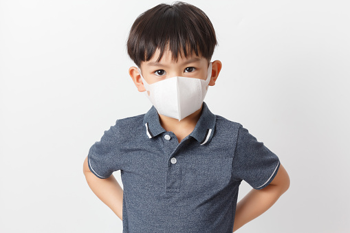 Asian child boy wearing a protection maskâ forâ preventâ against infection of Covid-19 virus outbreak or dust PM 2.5 air pollution.