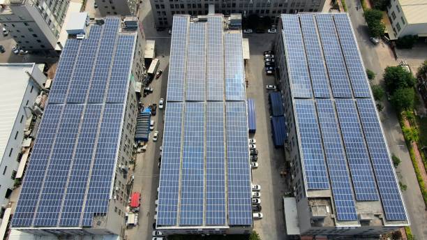 Roof space utilization, solar power roof Roof space utilization, solar power roof solar panels on the roof of building in a city stock pictures, royalty-free photos & images