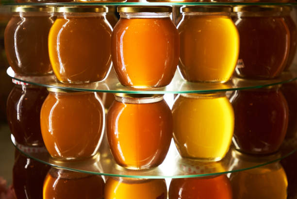 Jars of different honey varieties stocked on a shelf