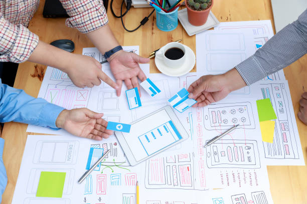 istock Graphic designers work together with UX UI designer planning application template layout framework for mobile phone computer mobile 1395640739