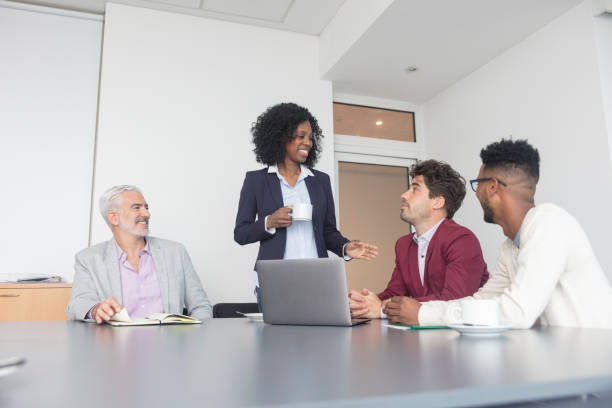 istock Young african american female boss explaining during meeting 1395641038