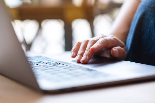 istock Closeup image of a woman using and touching on laptop computer touchpad 1395643625
