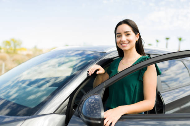 istock Happy young woman with a new car 1395643786