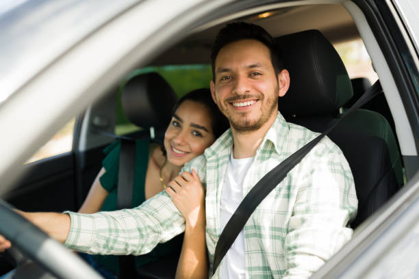 istock Attractive smiling couple in the car 1395644313