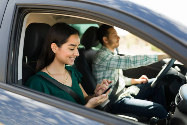istock Happy couple using gps on the phone while driving 1395644317
