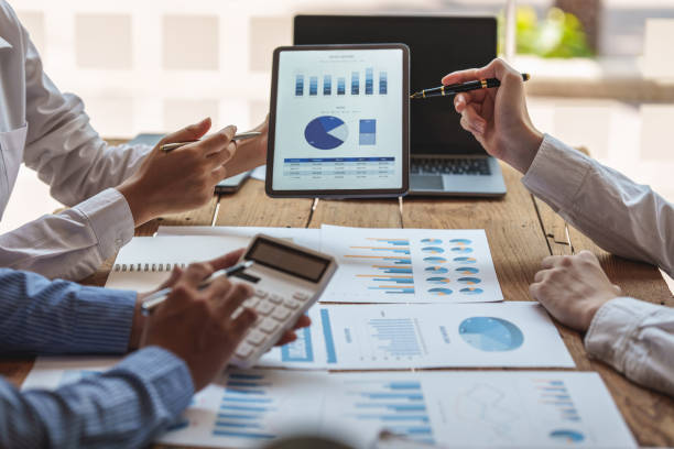 istock Group of IT consultant working by digital tablet and management big data and analyze financial document of company. 1395645338