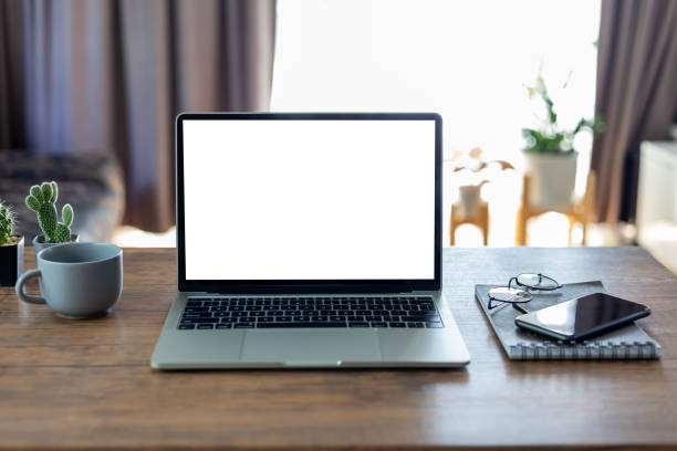 istock mock up empty screen computer on wood desk, Laptop computer with blank white screen on table in office.with clipping path 1395646259