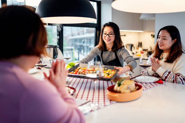 istock Asian chinese friends  having dinner at home 1395646355