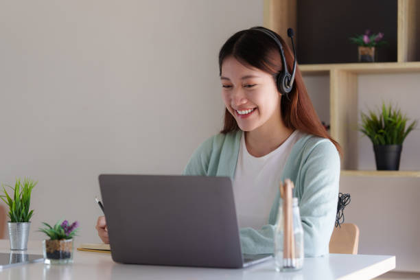 istock E-learning ,online ,education and internet social distancing protect from COVID-19 viruses concept. Asian woman student video conference e-learning with teacher on laptop computer at home. 1395646385