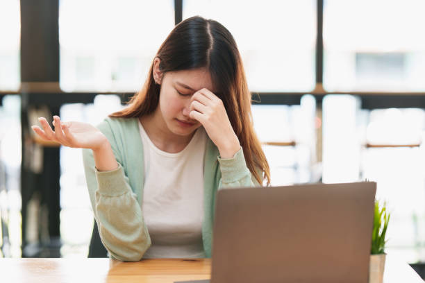 istock Frustrated young woman have problem while sitting at her working place. Business Stressed concept. 1395647035