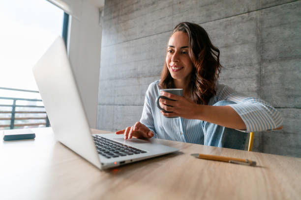 istock Happy woman working at home while drinking coffee 1395648133