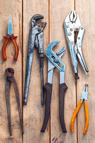 istock pliers over wooden board 139564894