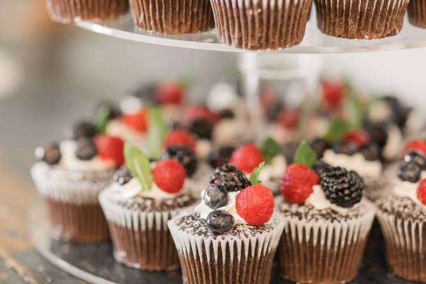 istock Fresh Berry Chocolate Cupcakes on a Dessert Bar at a Chic Neutral, Romantic Rustic Modern Style Wedding Reception Decor at a Spring Wedding in Tennessee 1395649970