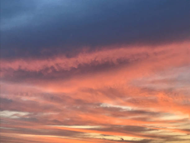 istock amazing blue, pink, and orange sunset sky with beautiful fluffy clouds 1395650902