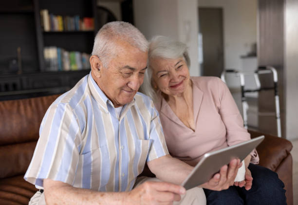 istock Happy senior couple using a tablet computer at home 1395651906