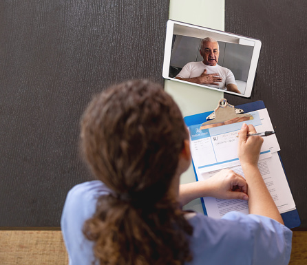 Latin American Senior man talking to the doctor on a virtual appointment - telemedicine concepts