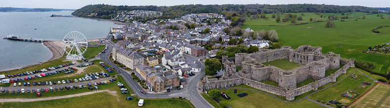 Drone point of view of small Welsh town with ferris wheel