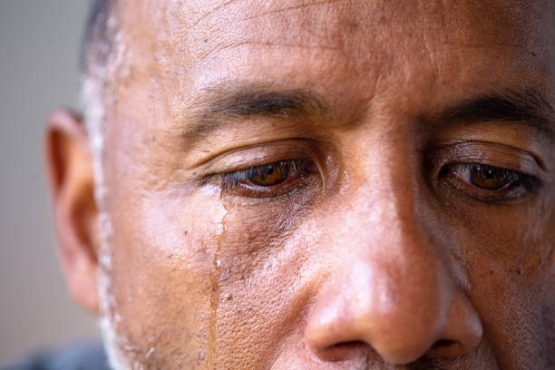 Portrait of a mature man looking sad with tears in his eyes. Mature African American man in deep thought looking sad. man crying stock pictures, royalty-free photos & images