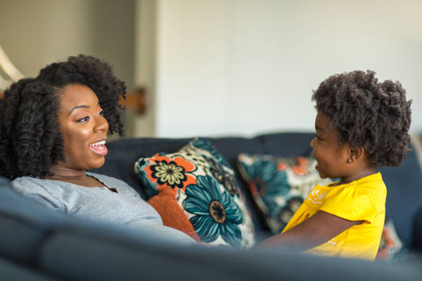 istock African American mother playing and talking with her daughter. 1395652921