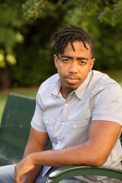 istock Young African American man in deep thought. 1395652937