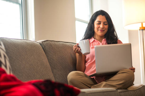 istock Hispanic woman at home working on a computer. 1395654235