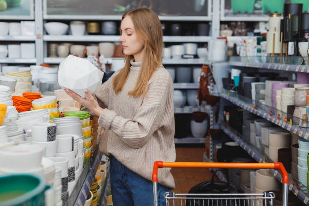 istock Woman choosing flower pot in hardware store 1395656882