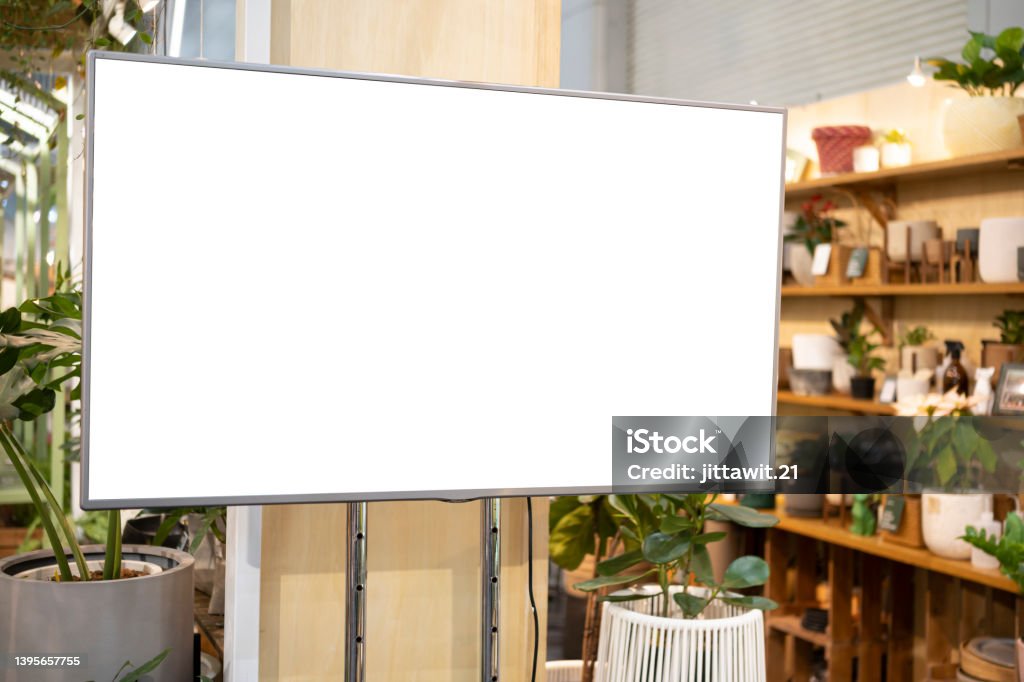 LCD Blank billboard for copy space in your text message or promotional content LCD television screen in a grocery store. green tree trunk background. LCD Blank billboard for copy space in your text message or promotional content LED Light Stock Photo